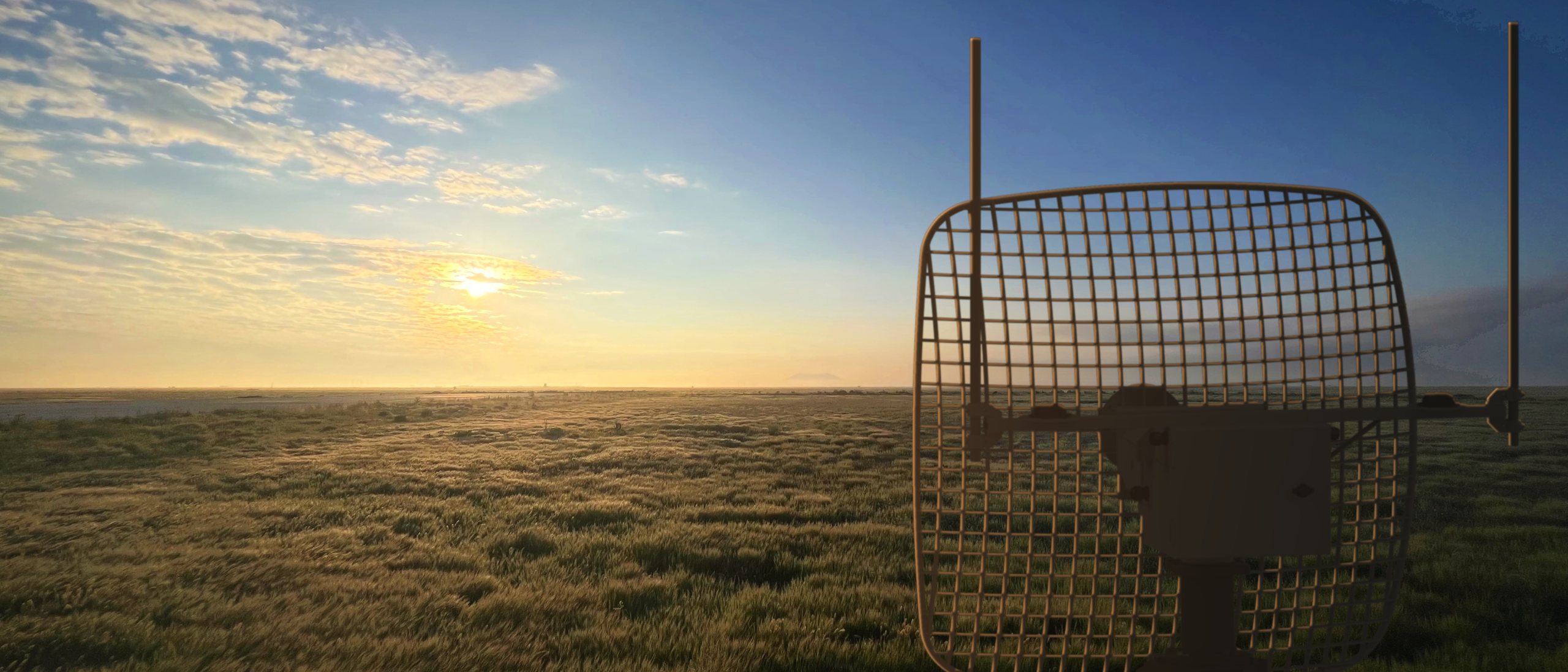 SkyBeam ground tracking antenna facing the horizon at sunrise