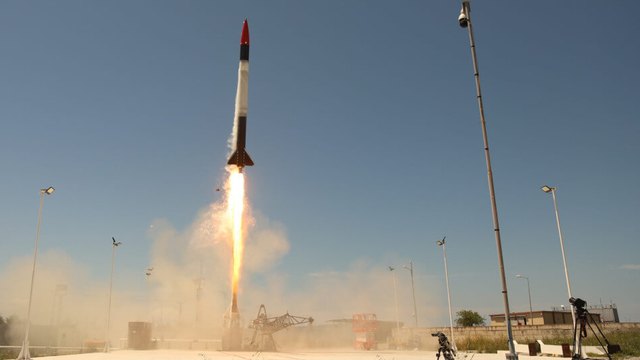 Rocket lifting off from a launch pad